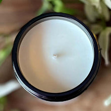 View of a soy wax candle from above showing the amber glass jar container.