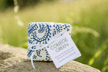 A wrapped bar of soap with label that says: College Green. Natural handmade soap with pure essential oils. Lavender & patchouli